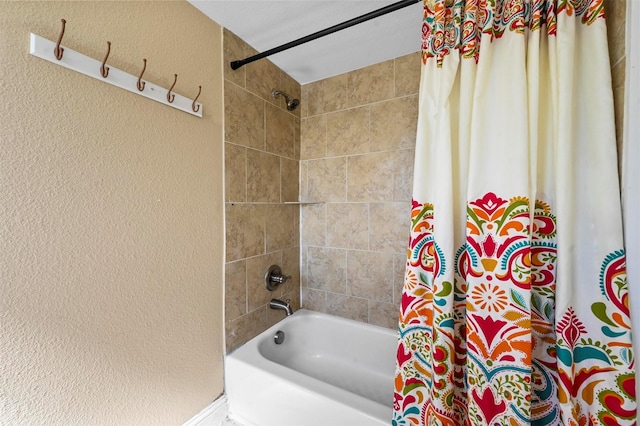 4001 Roswell St, Dallas, TX 75219 - bathroom with a textured wall and shower / bath combo with shower curtain