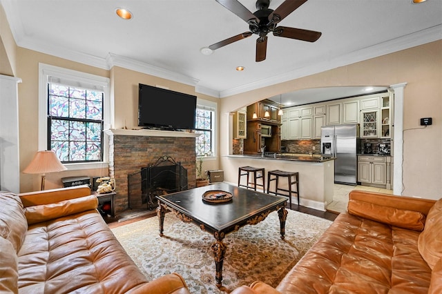 4001 Roswell St, Dallas, TX 75219 - living area with a fireplace, ornamental molding, ceiling fan, light wood-type flooring, and recessed lighting