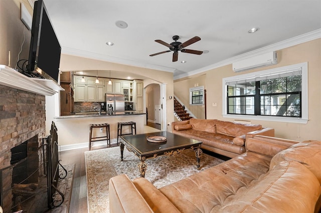 4001 Roswell St, Dallas, TX 75219 - living area featuring a wall unit AC, ceiling fan, ornamental molding, arched walkways, and light wood-type flooring