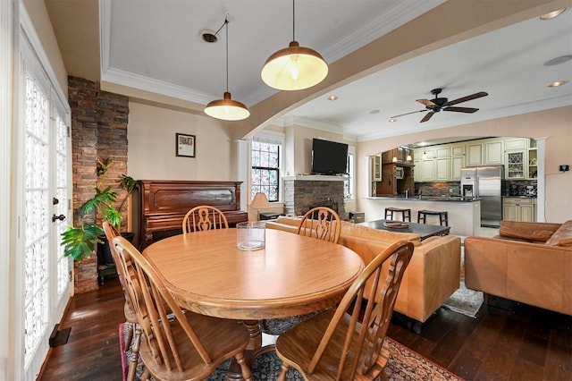 4001 Roswell St, Dallas, TX 75219 - dining area with dark wood-style flooring, crown molding, a fireplace, ceiling fan, and recessed lighting