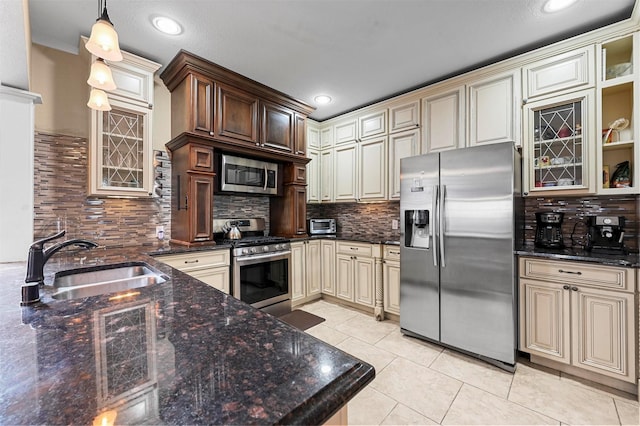 4001 Roswell St, Dallas, TX 75219 - kitchen with stainless steel appliances, cream cabinets, a sink, backsplash, and light tile patterned flooring