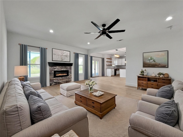 114 Trailridge Dr, Corsicana, TX 75110 - living room featuring recessed lighting, a stone fireplace, light wood finished floors, and a ceiling fan
