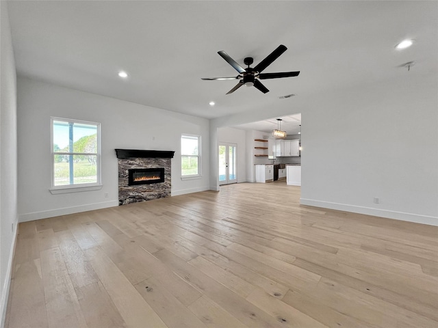 114 Trailridge Dr, Corsicana, TX 75110 - unfurnished living room with a fireplace, a wealth of natural light, and baseboards
