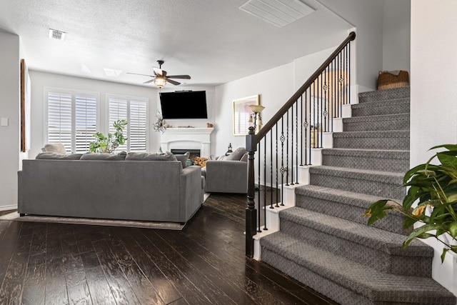 1753 Rio Penasco Rd, Fort Worth, TX 76052 - living room featuring stairs, dark wood-style floors, ceiling fan, and healthy amount of natural light