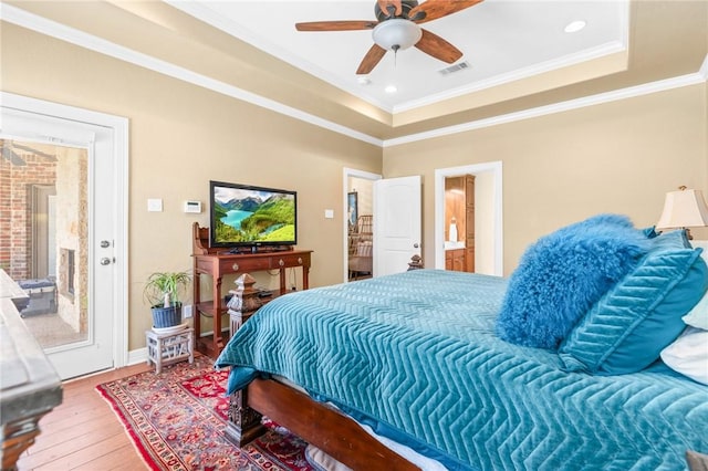8 Republic Dr, Waco, TX 76708 - bedroom with hardwood / wood-style flooring, ornamental molding, a tray ceiling, ensuite bath, and a ceiling fan
