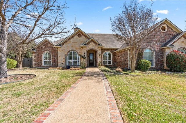 8 Republic Dr, Waco, TX 76708 - french provincial home featuring brick siding, a chimney, and a shingled roof