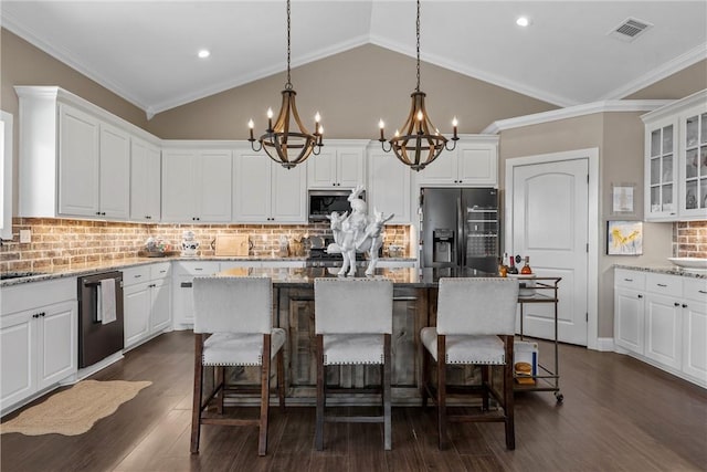 kitchen featuring visible vents, fridge with ice dispenser, stainless steel microwave, an inviting chandelier, and dishwasher
