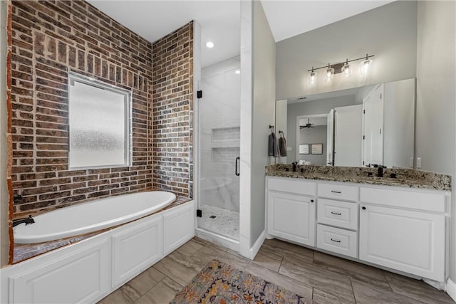 full bathroom with a stall shower, a bath, double vanity, and ceiling fan