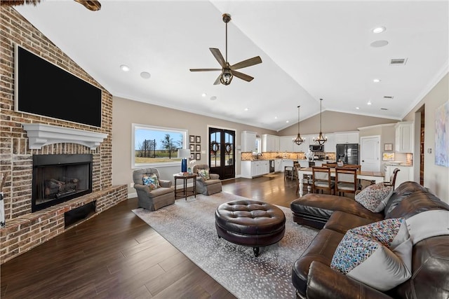 living room featuring visible vents, ceiling fan, lofted ceiling, ornamental molding, and dark wood-style flooring