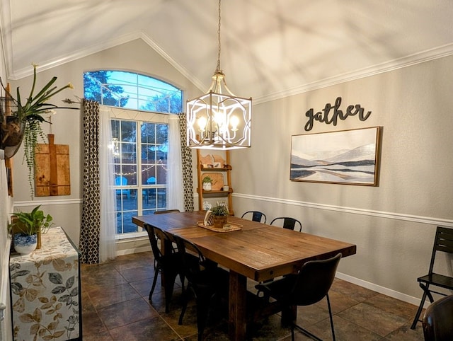 dining area featuring an inviting chandelier, crown molding, baseboards, and lofted ceiling