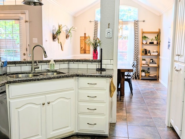 1231 Radisson Dr, Hewitt, TX 76643 - kitchen with a sink, vaulted ceiling, ornamental molding, dark stone counters, and white cabinetry