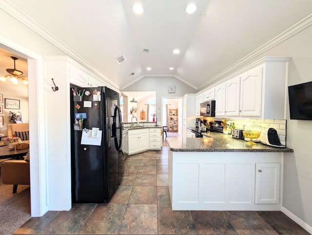 1231 Radisson Dr, Hewitt, TX 76643 - kitchen featuring black appliances, a peninsula, a sink, vaulted ceiling, and white cabinets