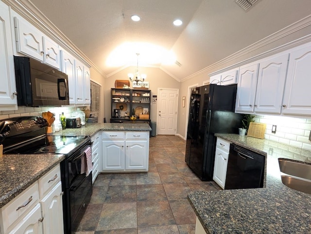 kitchen featuring a peninsula, black appliances, white cabinets, vaulted ceiling, and a chandelier