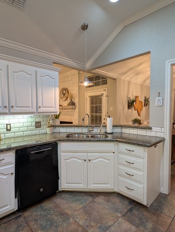 kitchen with black dishwasher, vaulted ceiling, ornamental molding, white cabinets, and a sink