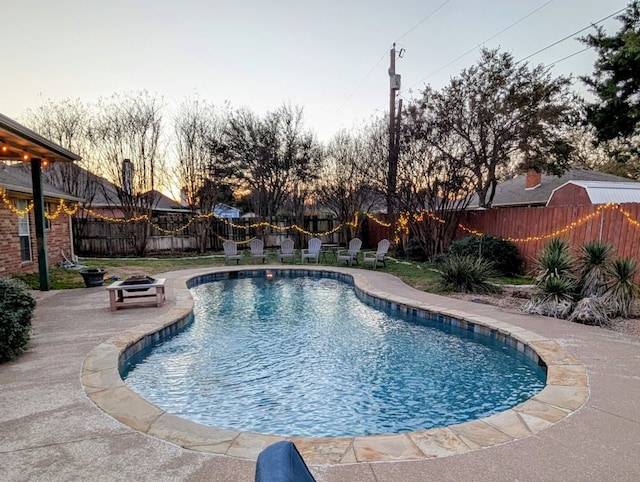 view of pool with a fenced in pool, an outdoor fire pit, a fenced backyard, and a patio area
