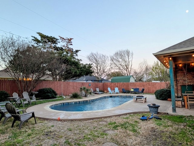 view of pool with a patio, a fenced backyard, and an outdoor fire pit