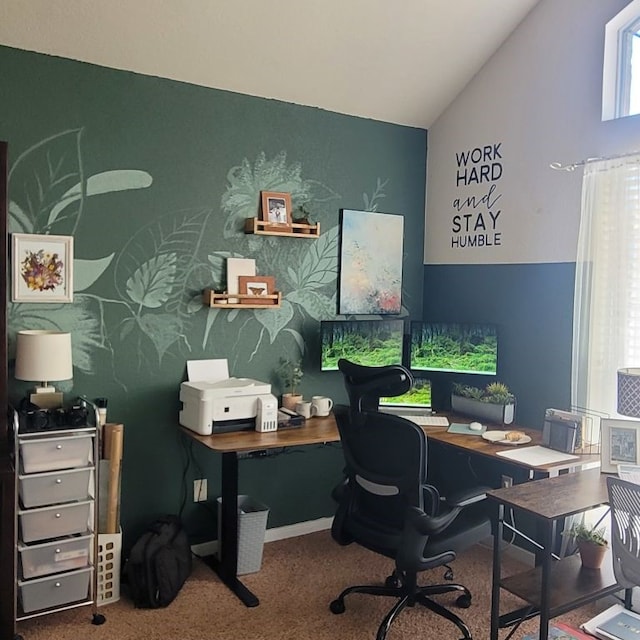 carpeted office space featuring wallpapered walls, lofted ceiling, baseboards, and an accent wall