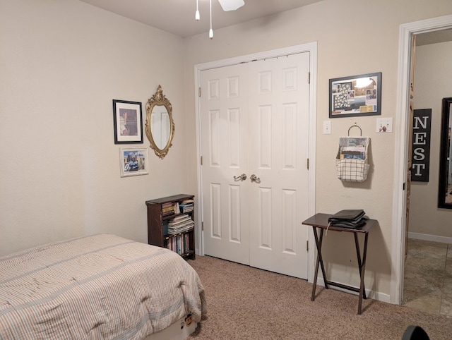 bedroom featuring a closet, baseboards, and carpet flooring
