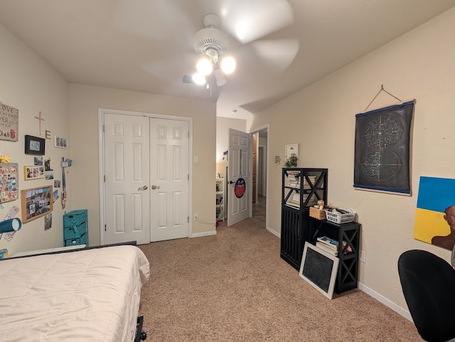 carpeted bedroom with a closet, a ceiling fan, and baseboards