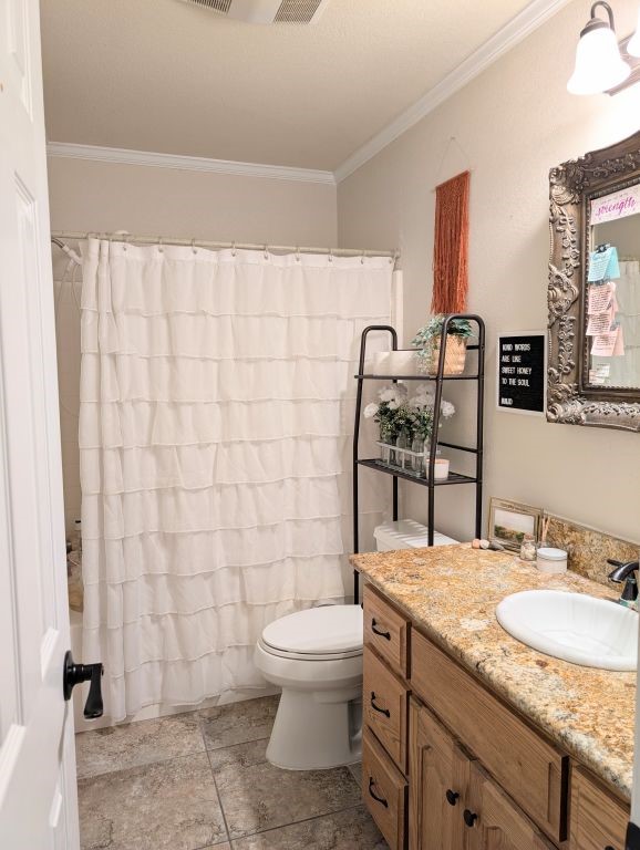 bathroom with shower / bath combo with shower curtain, vanity, toilet, and crown molding