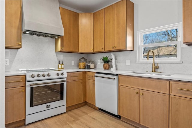 2211 Morrow Ave, Waco, TX 76707 - kitchen featuring white appliances, custom exhaust hood, a sink, light countertops, and light wood-style floors