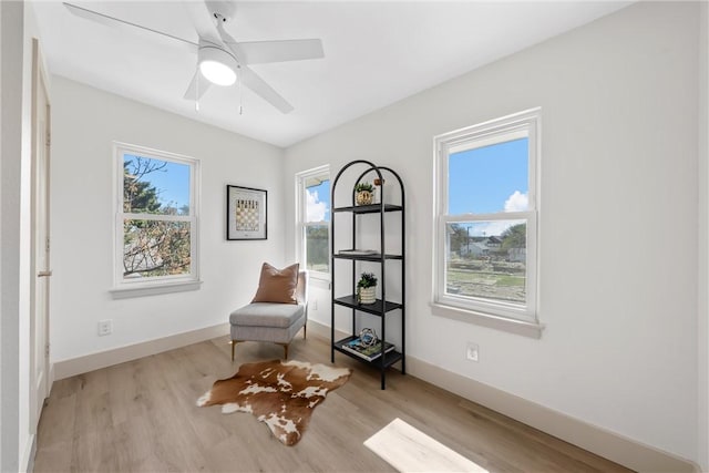 2211 Morrow Ave, Waco, TX 76707 - living area featuring wood finished floors, baseboards, and a ceiling fan