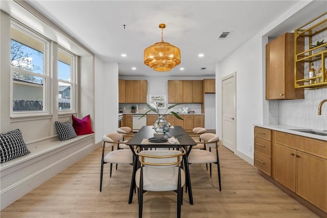 2211 Morrow Ave, Waco, TX 76707 - dining space with recessed lighting, light wood-style flooring, and a chandelier