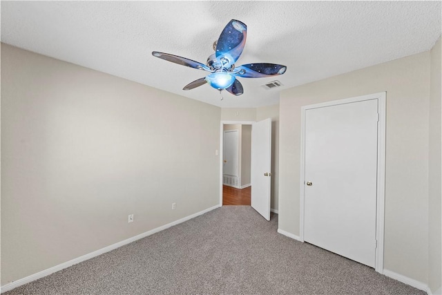 1901 Ruidoso Dr, Waco, TX 76712 - unfurnished bedroom featuring carpet floors, baseboards, ceiling fan, and a textured ceiling