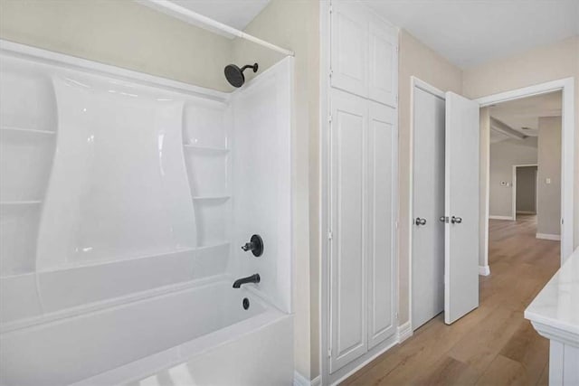 bathroom with shower / tub combination and wood finished floors