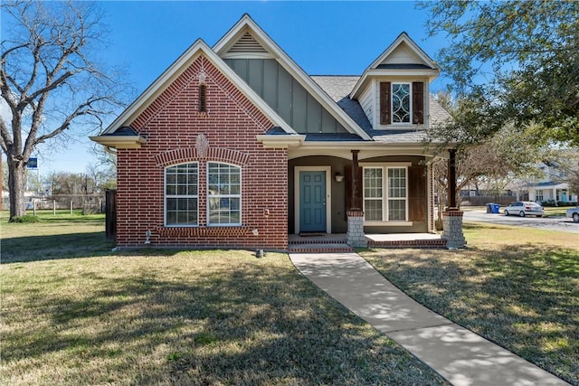 2124 S 4th St, Waco, TX 76706 - view of front of property with a front lawn, brick siding, board and batten siding, and covered porch