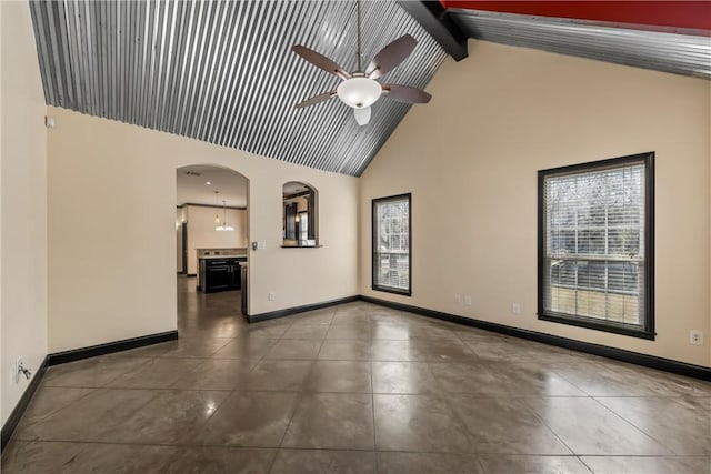 2124 S 4th St, Waco, TX 76706 - tiled spare room featuring a ceiling fan, beamed ceiling, arched walkways, baseboards, and high vaulted ceiling