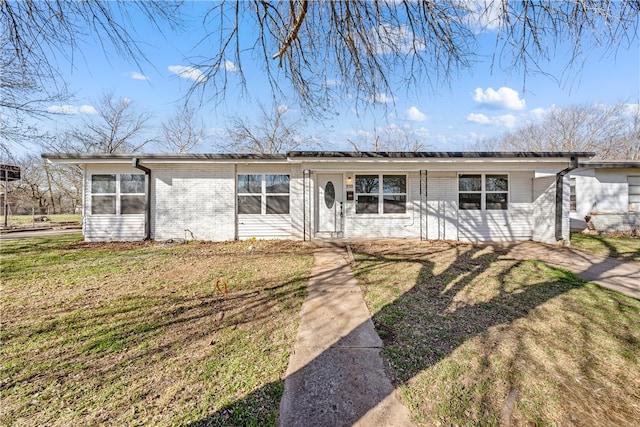 ranch-style house with a front yard and brick siding