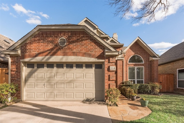 view of front facade featuring brick siding, a chimney, concrete driveway, and a garage