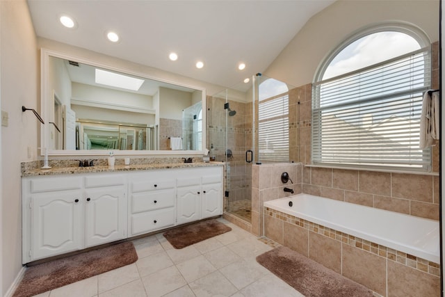 bathroom with double vanity, recessed lighting, a stall shower, a garden tub, and tile patterned floors