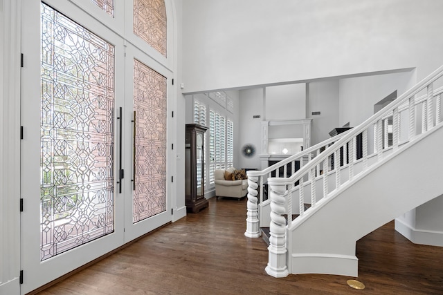7607 Monticello Pkwy, Colleyville, TX 76034 - foyer featuring wood finished floors, a high ceiling, and stairway