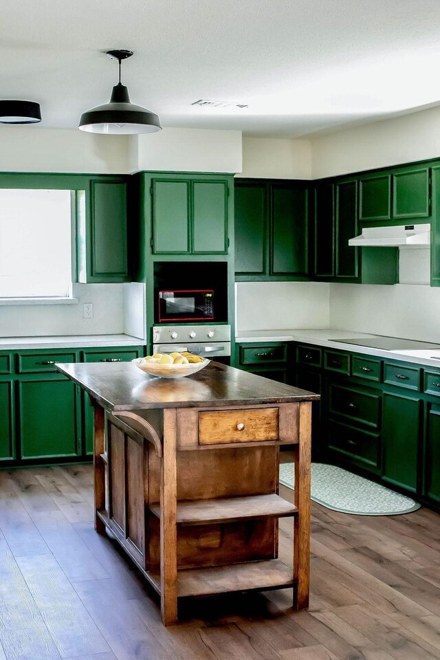 5204 Mansfield Rd, Arlington, TX 76017 - kitchen with green cabinetry, open shelves, black appliances, and under cabinet range hood
