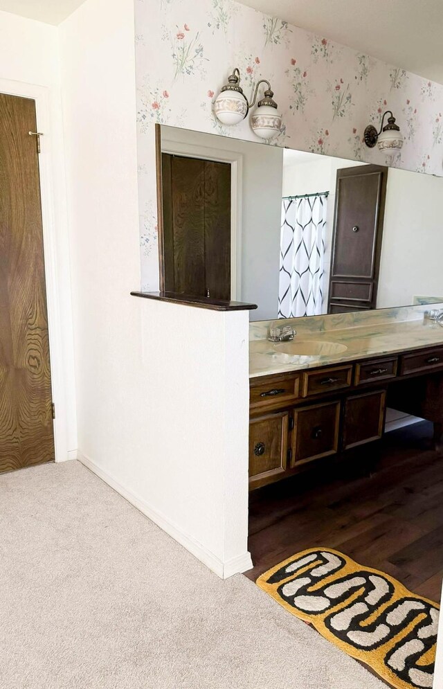 5204 Mansfield Rd, Arlington, TX 76017 - bathroom with wallpapered walls, vanity, and baseboards