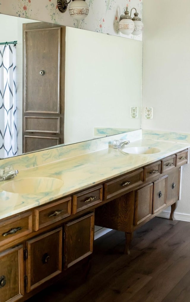 5204 Mansfield Rd, Arlington, TX 76017 - full bath with wood finished floors, a shower with shower curtain, wallpapered walls, baseboards, and vanity