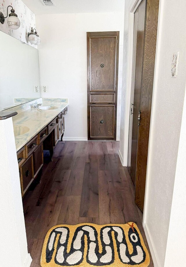 5204 Mansfield Rd, Arlington, TX 76017 - bathroom with double vanity, visible vents, wood finished floors, and a sink