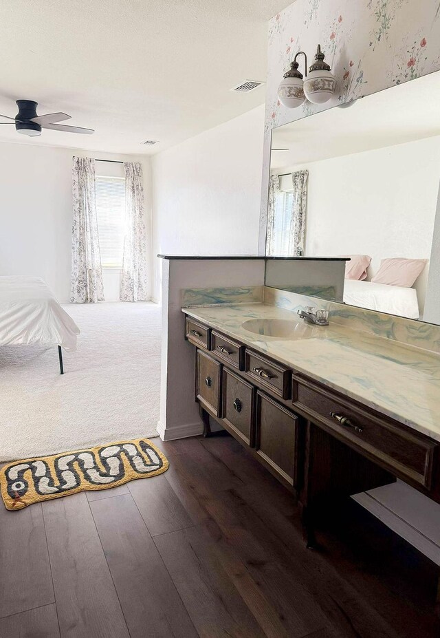 5204 Mansfield Rd, Arlington, TX 76017 - bathroom featuring vanity, wood finished floors, a ceiling fan, and visible vents