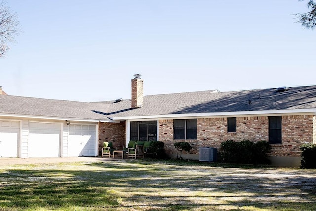 5204 Mansfield Rd, Arlington, TX 76017 - view of front of home featuring an attached garage, a shingled roof, a chimney, a front lawn, and brick siding