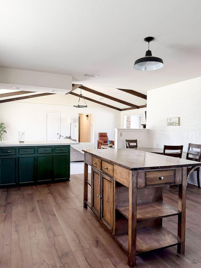 5204 Mansfield Rd, Arlington, TX 76017 - kitchen featuring visible vents, decorative light fixtures, a textured ceiling, wood finished floors, and vaulted ceiling with beams