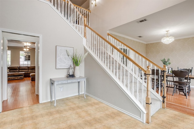 2212 Summit Dr, Burleson, TX 76028 - staircase with wallpapered walls, a chandelier, ornamental molding, and baseboards