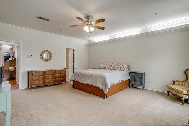bedroom featuring ceiling fan, carpet floors, ornamental molding, and visible vents