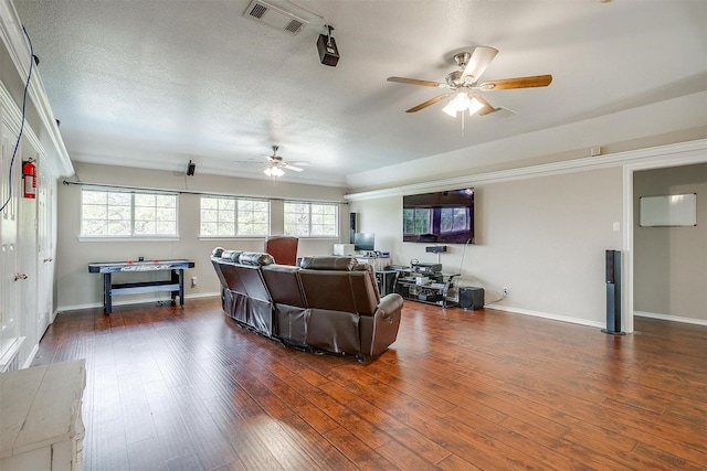 2212 Summit Dr, Burleson, TX 76028 - living room with ceiling fan, dark wood finished floors, baseboards, ornamental molding, and a textured ceiling