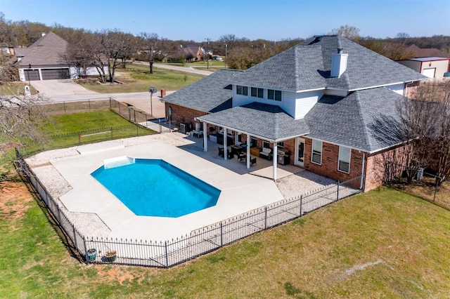 view of pool with a fenced backyard, a patio area, a fenced in pool, and a lawn