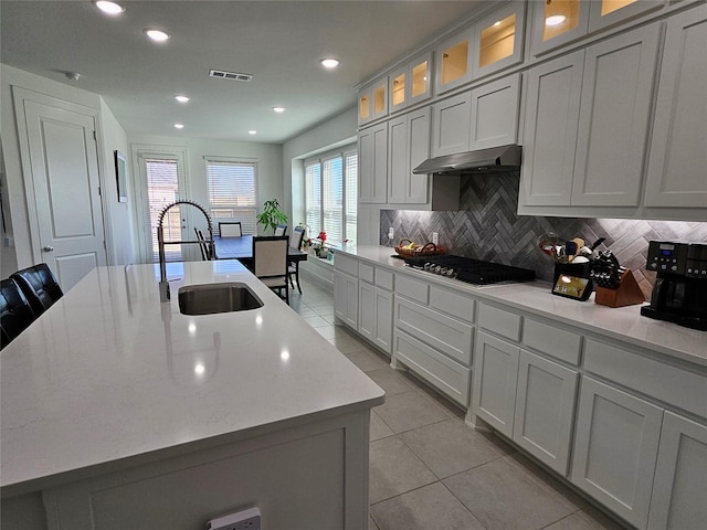 2856 Chester Dr, Celina, TX 75009 - kitchen with visible vents, a center island with sink, under cabinet range hood, a sink, and gas stovetop