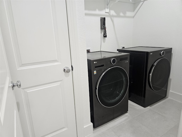 2856 Chester Dr, Celina, TX 75009 - laundry room featuring light tile patterned floors, laundry area, and washer and clothes dryer