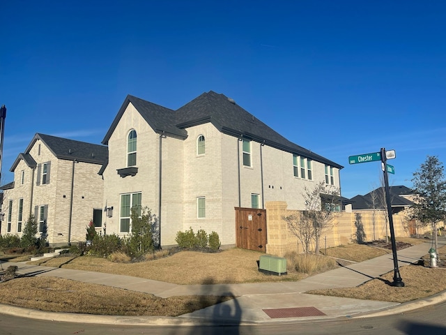 2856 Chester Dr, Celina, TX 75009 - view of home's exterior featuring brick siding, central AC unit, and fence