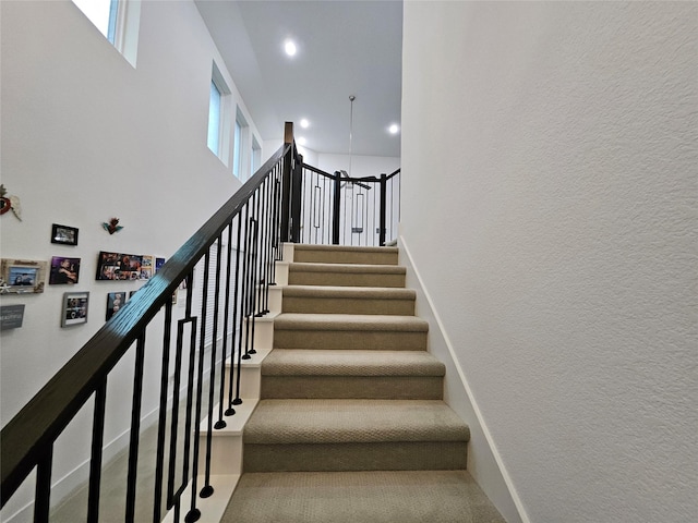 2856 Chester Dr, Celina, TX 75009 - stairway with recessed lighting, a high ceiling, a textured wall, and a healthy amount of sunlight